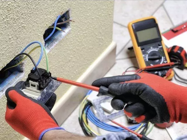 hands installing residential electrical outlet 