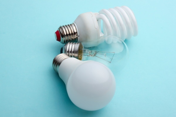 Energy saving and incandescent light bulb close-up on a blue pastel background